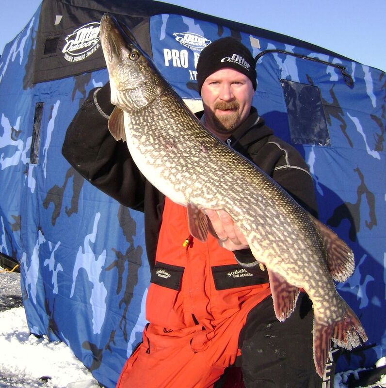 fisherman holding a large northern pike he caught using Big Nasty Tackle